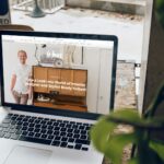 MacBook Pro on top of brown wooden table during daytime